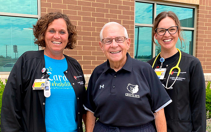 Father Fred stands outside UH Lake Brunner Sanden Deitrick Wellness Center
