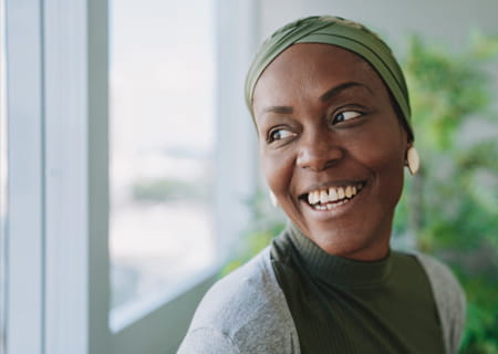 Female patient smiling and looking sideways out a window